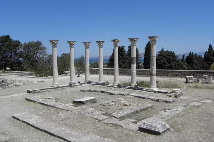 Ancient Corinth ruins with restored columns and foundations on a private tour from Athens to Peloponnese