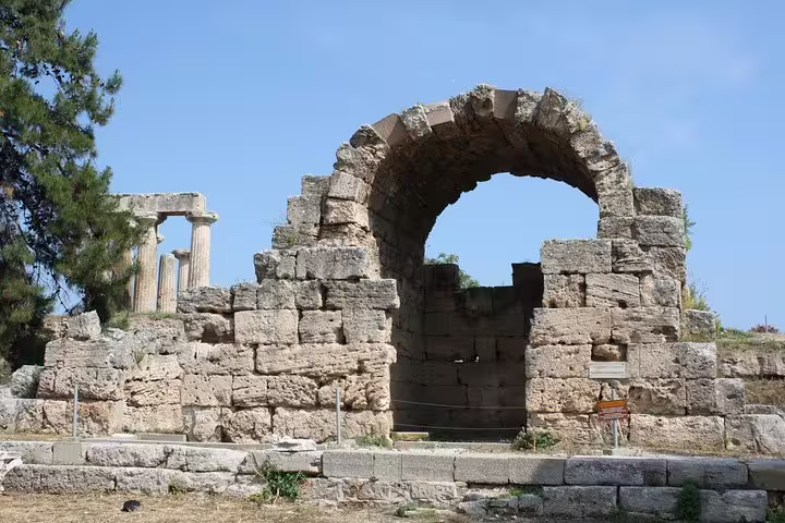 Ancient Corinth ruins with Roman arch and columns, highlight stop on Epidaurus Nafplio private tour