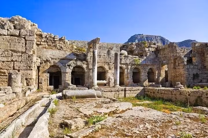 Stone arches and columns in Ancient Corinth archaeological site, featured on Explore Athens & Biblical Corinth tour