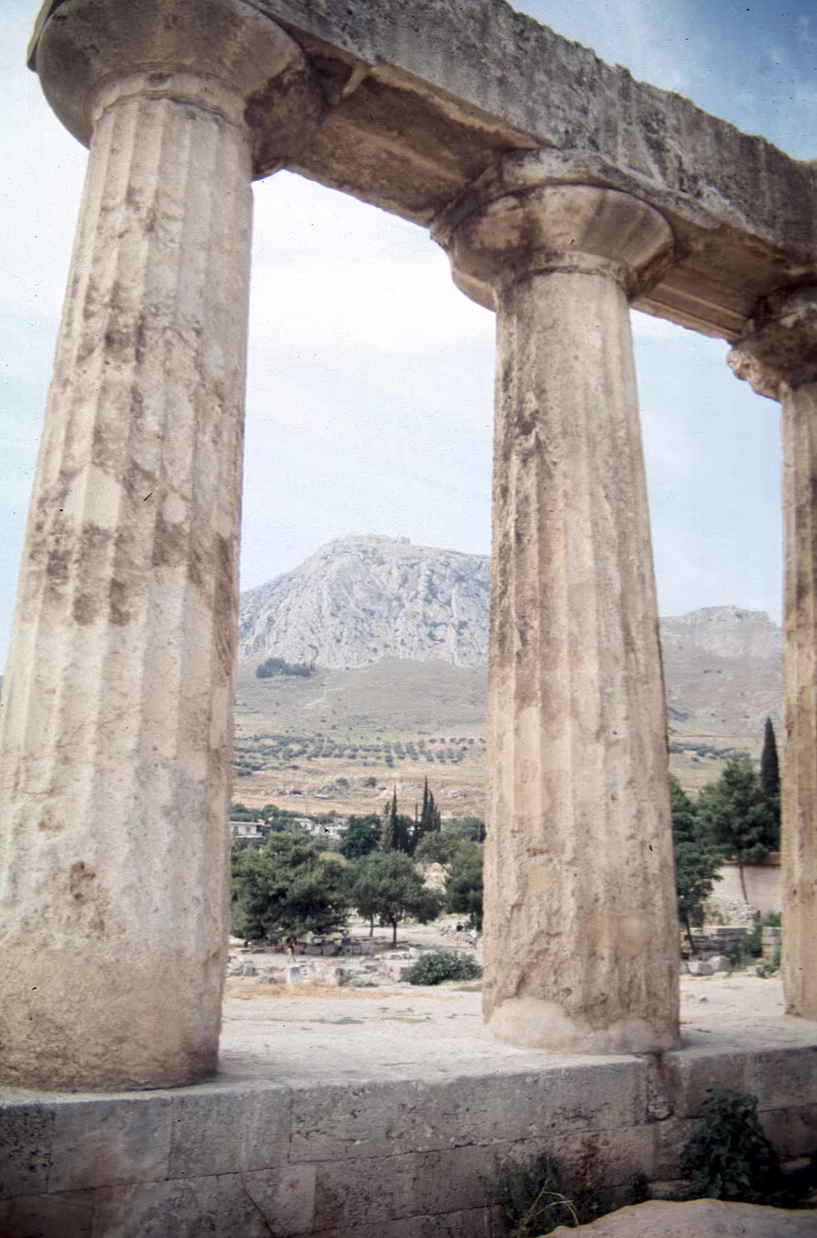 Ancient Corinth temple columns with Acrocorinth mountain view on a private day tour from Athens