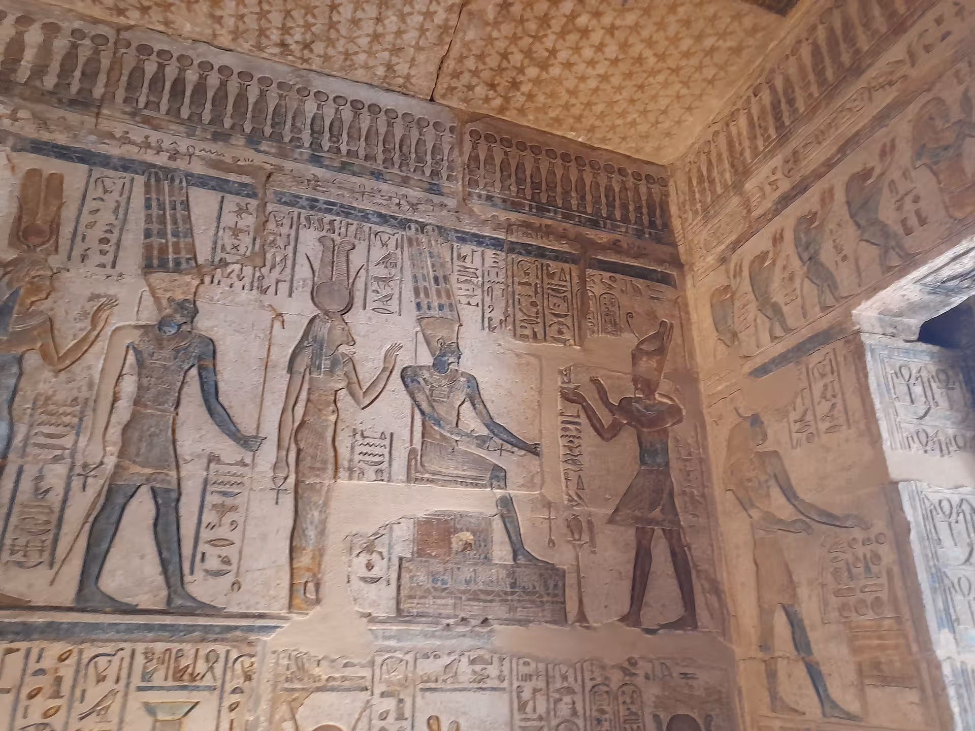 Ancient Egyptian hieroglyphics and deities carved on temple walls in the Valley of the Nile.