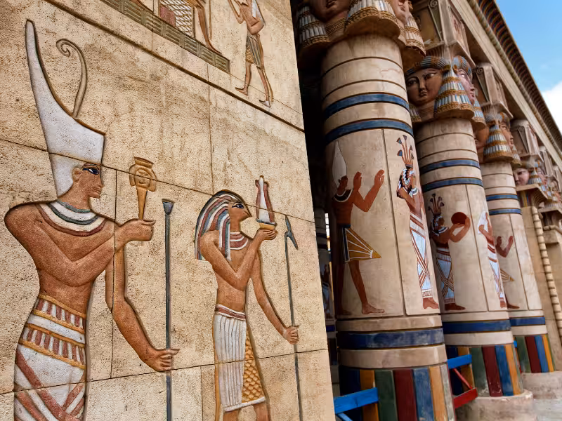 Painted ancient Egyptian temple reliefs and columns, cultural highlights on Golden Egypt tour itinerary