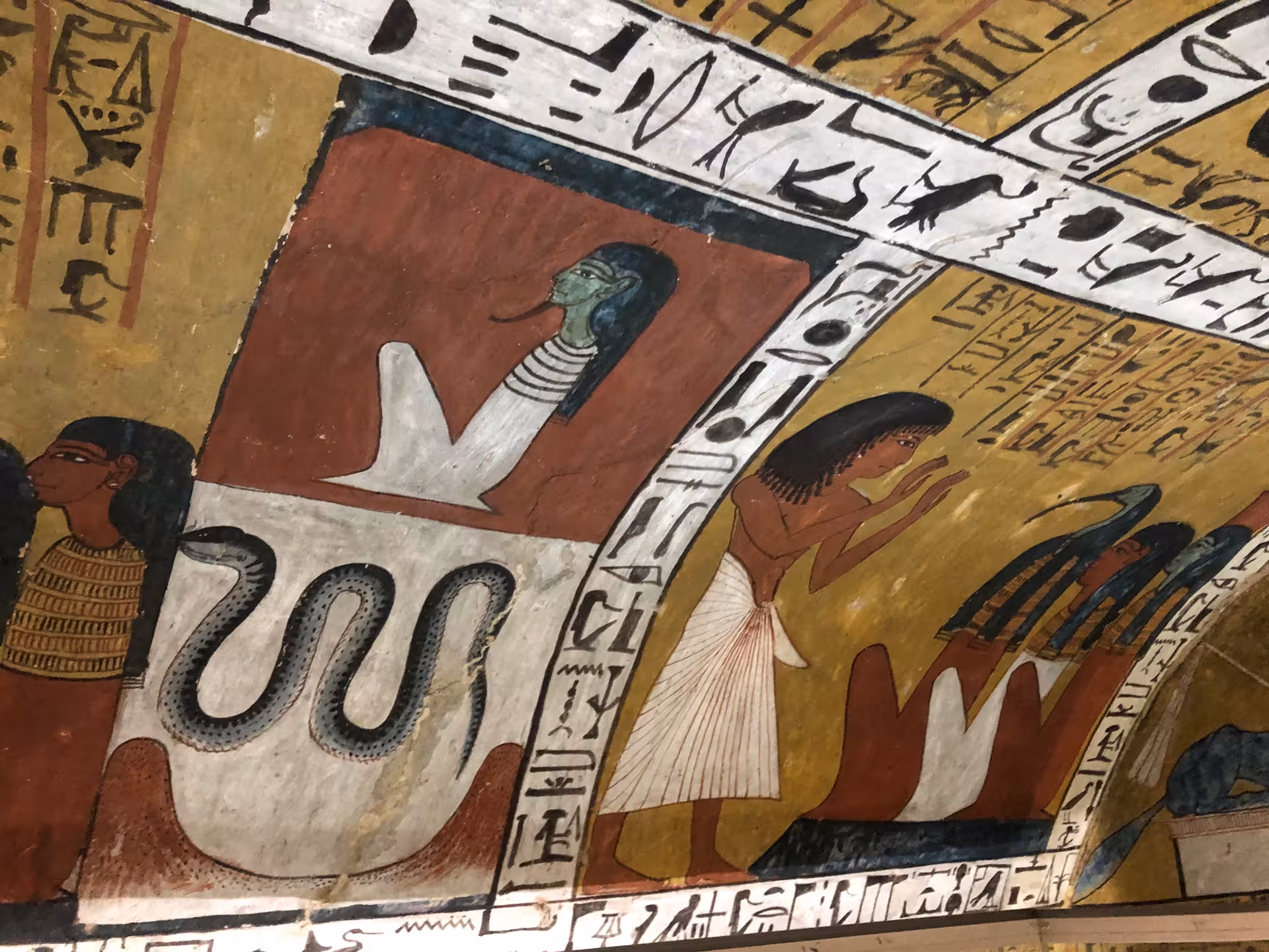 Ancient Egyptian tomb paintings featuring hieroglyphics and deities, showcasing Egypt's rich cultural heritage.