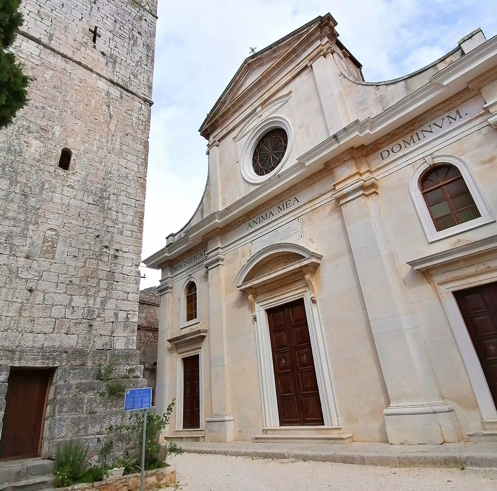 Historic church facade and stone bell tower in Bale, a highlight on the Ancient Istria tour from Pula