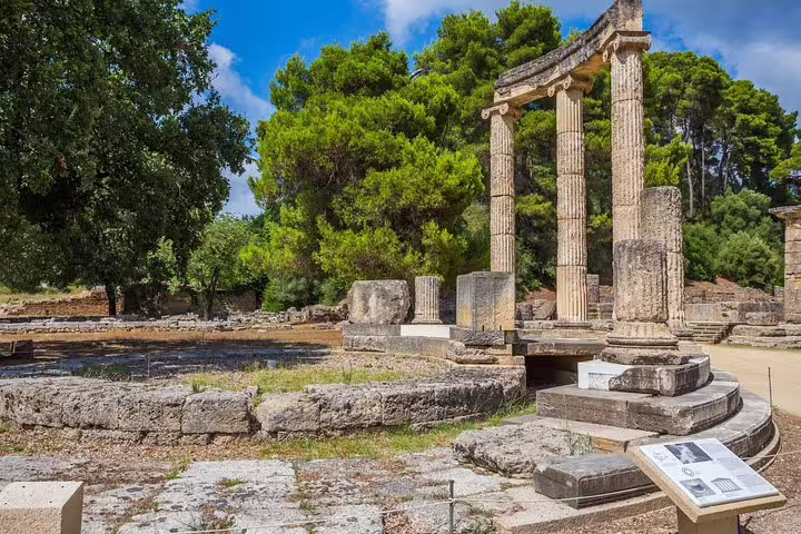 Ancient Olympia archaeological site ruins with Doric columns, featured on a full-day private tour from Athens