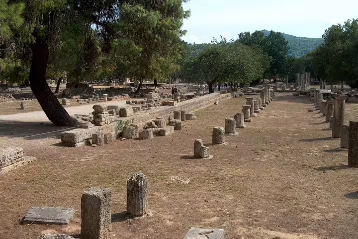 Ruins and column bases at Ancient Olympia archaeological site, highlight of full-day private guided tour from Athens