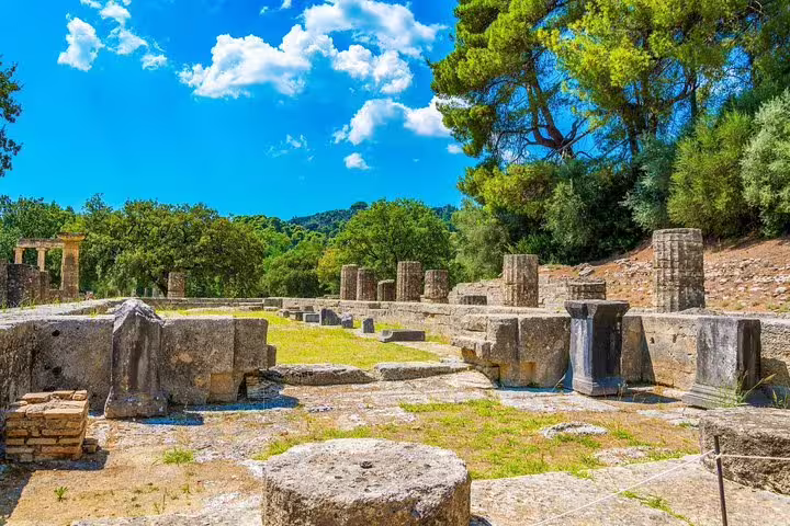 Sunlit ruins and columns at Ancient Olympia archaeological site, scenic stop on Olympia full day tour