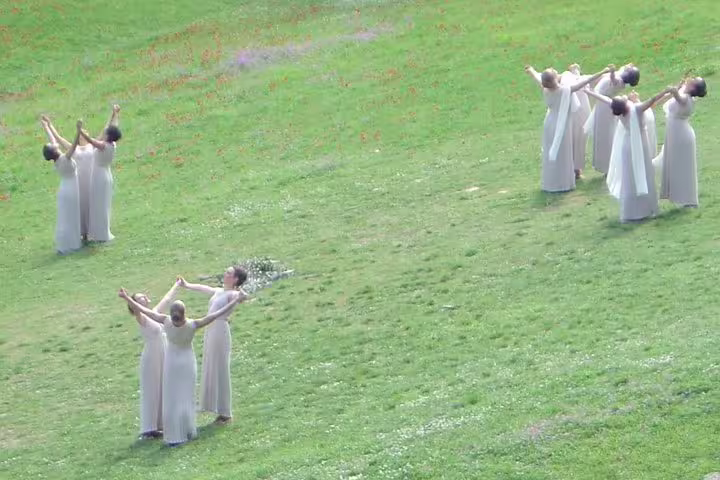 Traditional performance on the Olympia stadium field, seen on Ancient Olympia full-day private guided tour from Athens