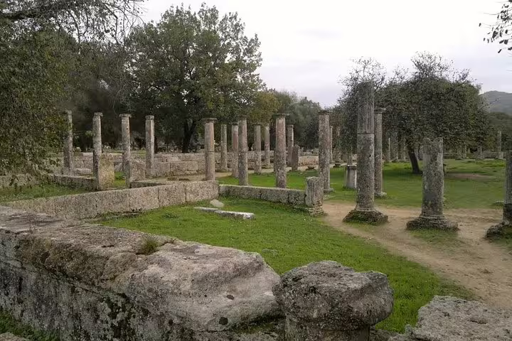 Stone columns and pathways at Ancient Olympia ruins, highlight of full-day private Athens to Olympia tour
