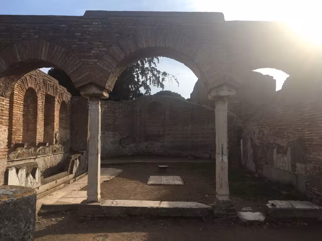 Sunlit arches and columns at Ancient Ostia, a highlight of the Fiat '500 vintage tour.