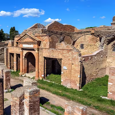 Discover the well-preserved ancient architecture of Ostia Antica on a classic Fiat '500 tour.