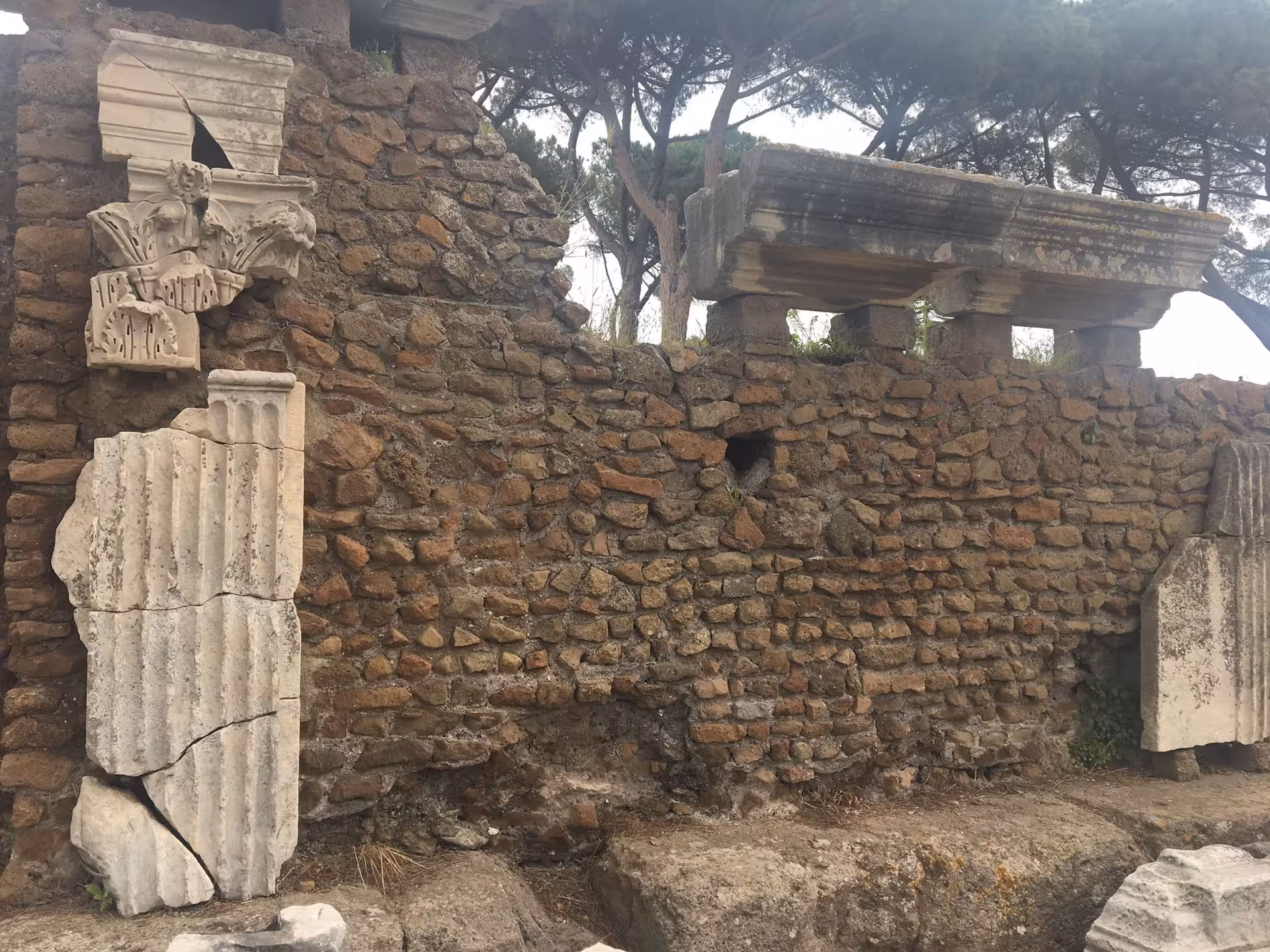 Detailed stone carvings and ancient ruins in Ostia, highlighting historical exploration on the vintage Fiat 500 tour.