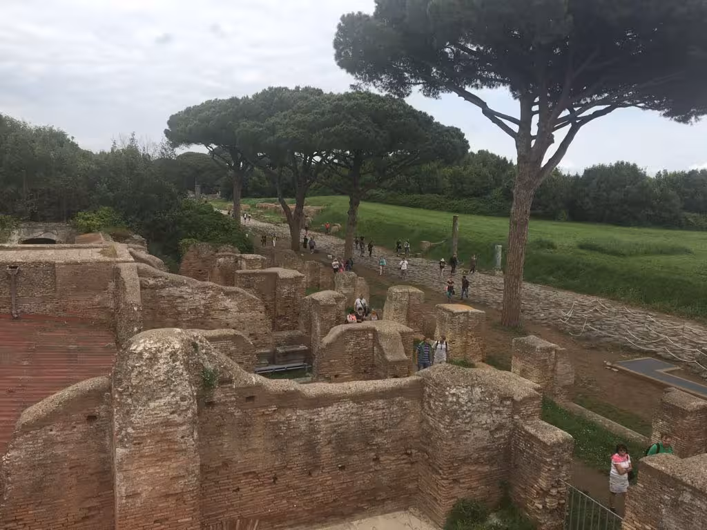 Scenic view of Ancient Ostia ruins surrounded by lush greenery, ideal for historical exploration on a vintage tour.