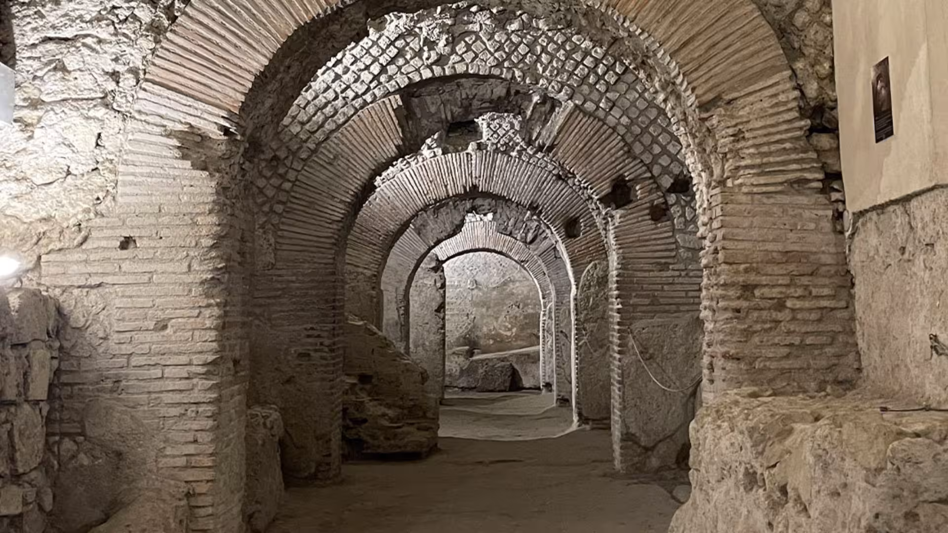 Explore ancient Roman arches in Naples' Greek-Roman ruins, showcasing intricate brick masonry and historic architecture.
