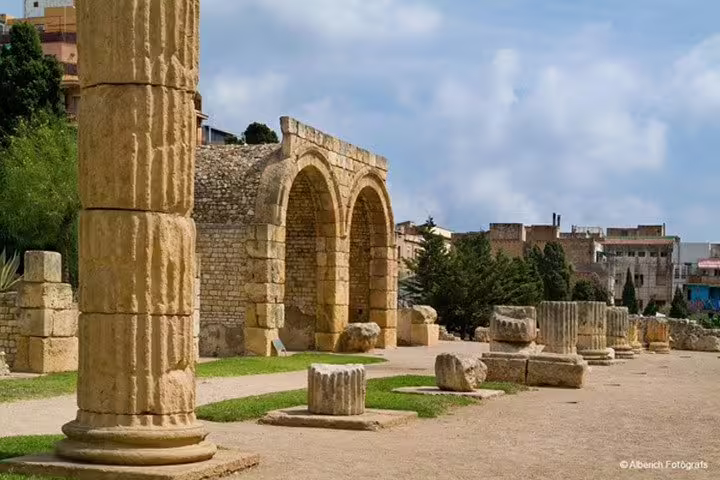 Explore the ancient Roman ruins in Tarragona, showcasing impressive arches and columns under a clear blue sky.