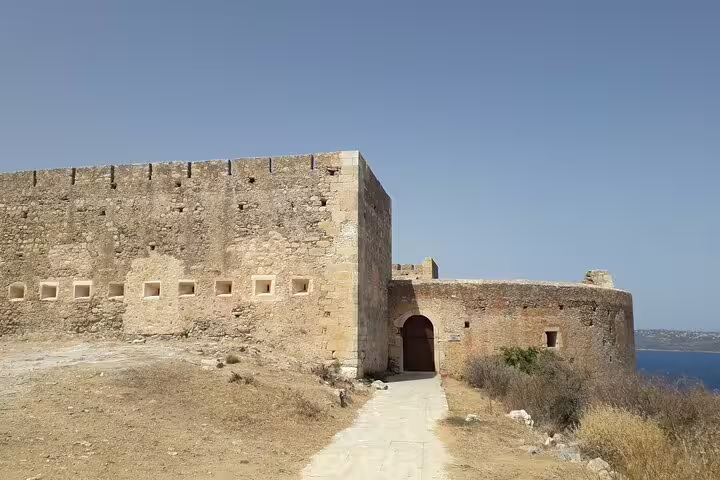 Entrance to a well-preserved ancient stone fortress, highlighting the rich history on the Paths of Old Cretan Life tour from Chania.