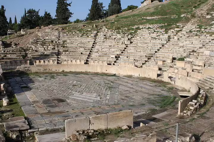 Ancient Theatre of Dionysus seating on Acropolis slope, key stop on a full-day private Athens tour