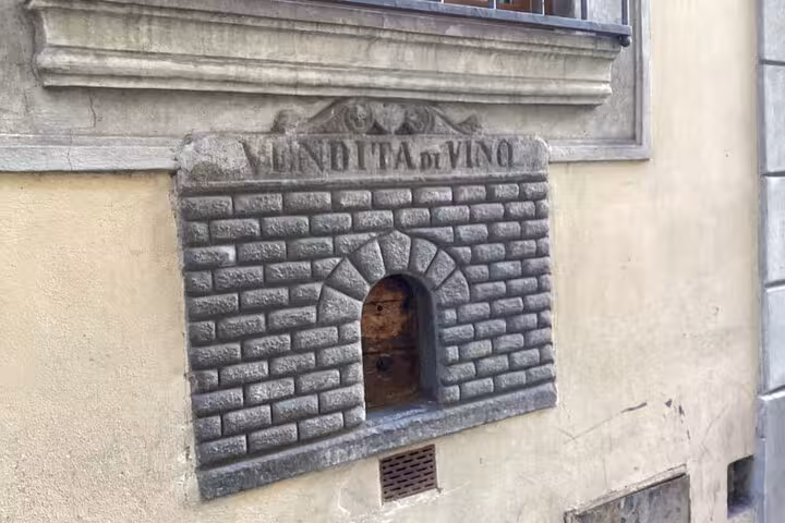 Close-up of an ancient wine window, a unique feature explored on the Wine Windows Walk tour in Florence.