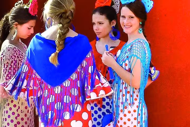 Colorful flamenco dresses at a vibrant Andalusian festival, showcasing cultural highlights of the 5-day tour.