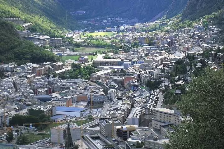 Panoramic view of Andorra la Vella nestled in the Pyrenees, showcasing urban architecture and lush valleys.