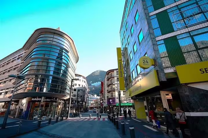 Modern shopping street in Andorra la Vella with contemporary buildings and vibrant city life.