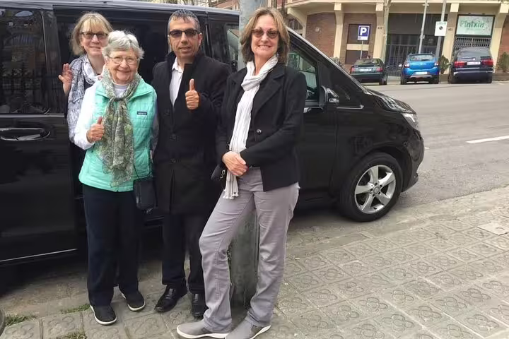 Group of tourists posing with guide in Andorra, ready for a personalized sightseeing adventure in the Pyrenees.