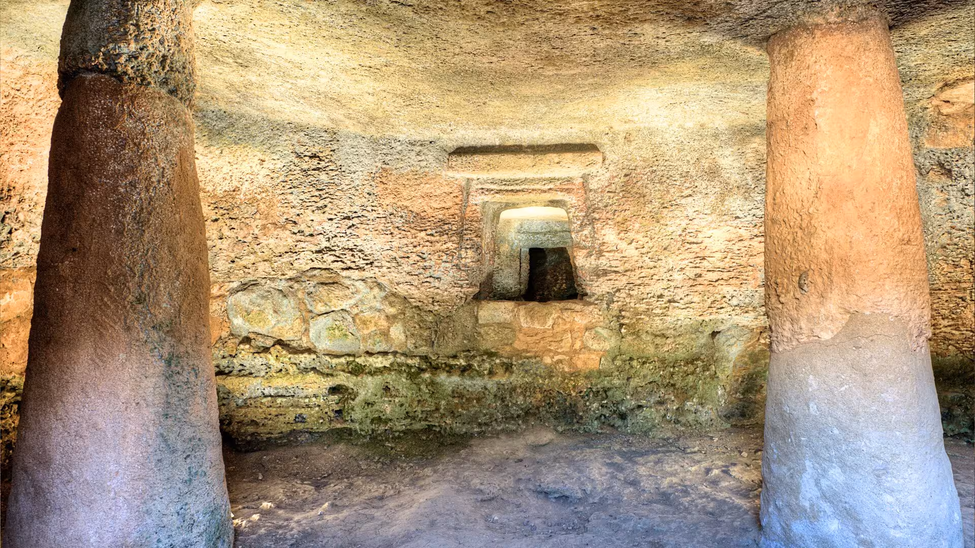 Discover the captivating interior of Anghelu Ruju Necropolis, showcasing ancient stone formations and historical architecture.