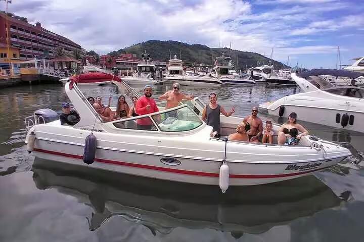 Group of tourists on a boat tour at Angra dos Reis, enjoying a vibrant atmosphere and beautiful marina views.