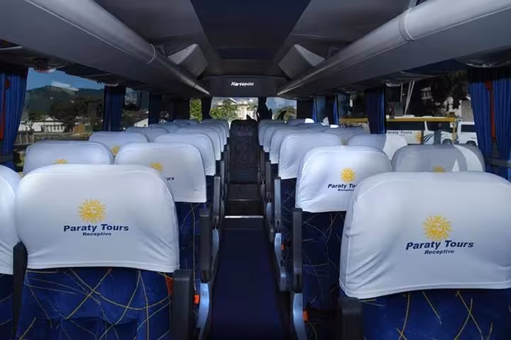 Interior of a Paraty Tours shuttle bus with comfortable seating for transfers from Angra dos Reis to Paraty.