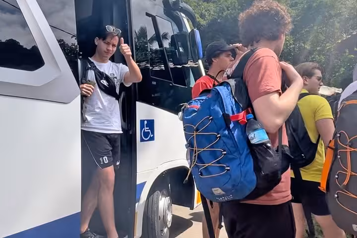 Travelers disembark from a shuttle bus in Angra dos Reis for a shared transfer to Paraty, Brazil.