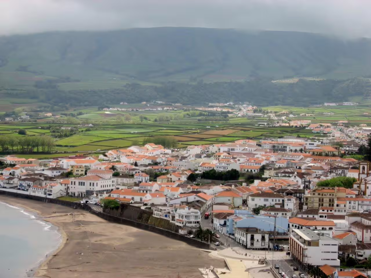 Aerial view of Angra do Heroísmo with its historic buildings and lush green landscape, perfect for a Terceira Island self-drive tour.