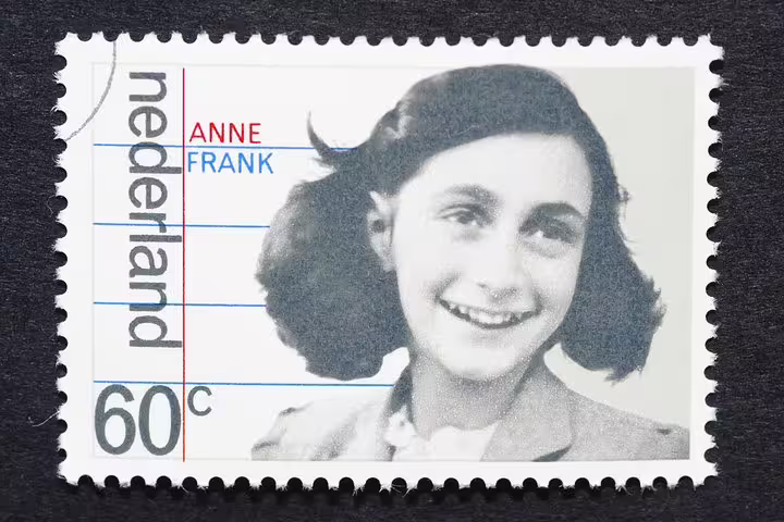 A vintage postage stamp featuring Anne Frank, ideal for promoting the Anne Frank Walking Tour in Amsterdam's Jewish Cultural Quarter.