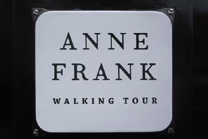 Anne Frank Walking Tour sign in Amsterdam's Jewish Cultural Quarter, highlighting historical exploration and cultural insights.