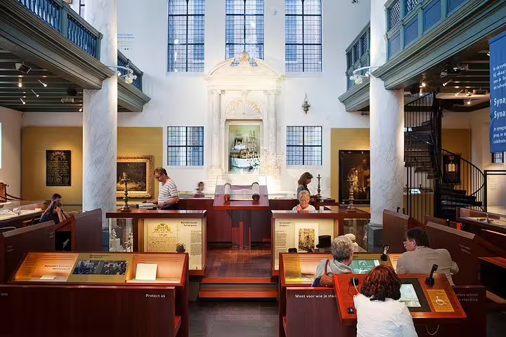 Visitors explore exhibits in the Jewish Cultural Quarter, part of the Anne Frank Walking Tour in Amsterdam.