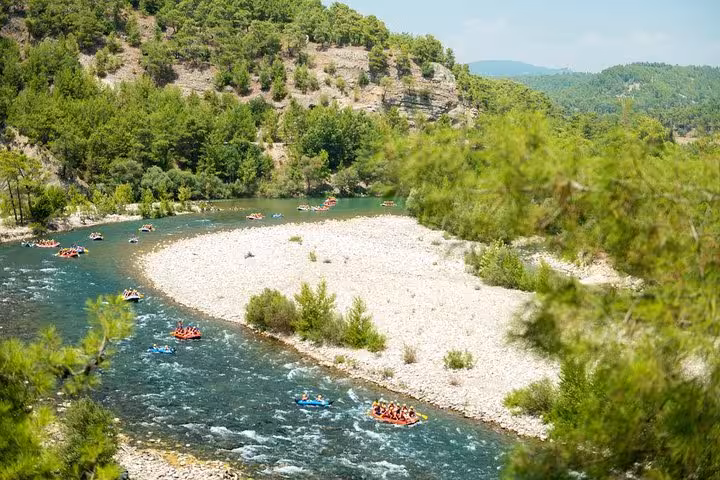Scenic Köprülü Canyon river bend with rafting boats on Antalya rafting tour in lush pine forest