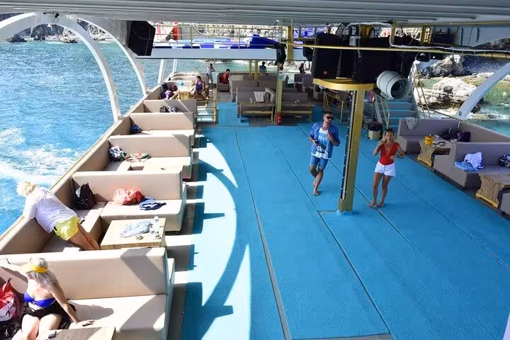 Open-air deck on Antalya Mediterranean coast boat tour, comfy lounges, turquoise water and onboard lunch