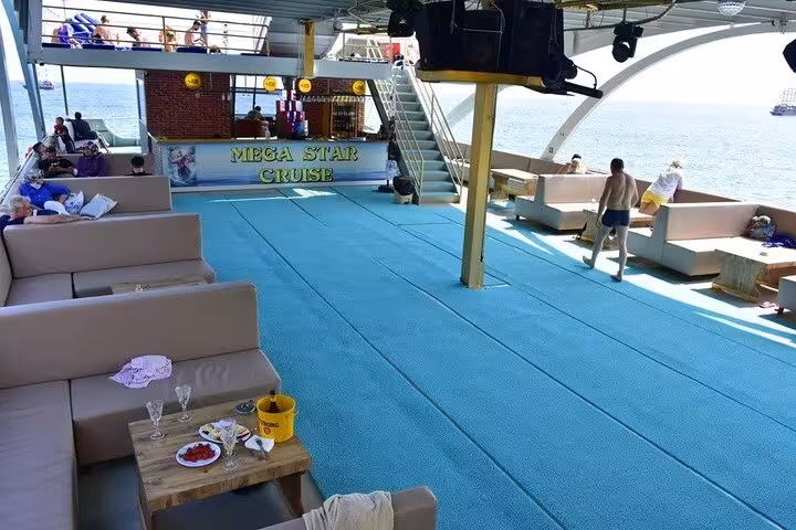 Spacious Mega Star cruise deck on Antalya boat tour, Mediterranean sea views, relaxing seating and lunch
