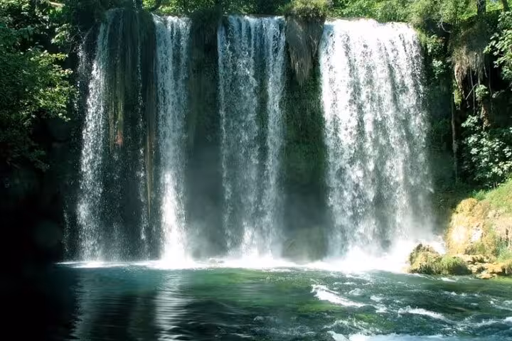 Antalya private 3 natural wonders waterfall tour with cascading falls into a turquoise pool, lush forest