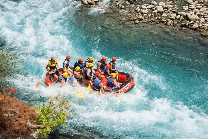 Group in red raft tackling whitewater rapids on Köprülü Canyon, Antalya rafting tour with helmets