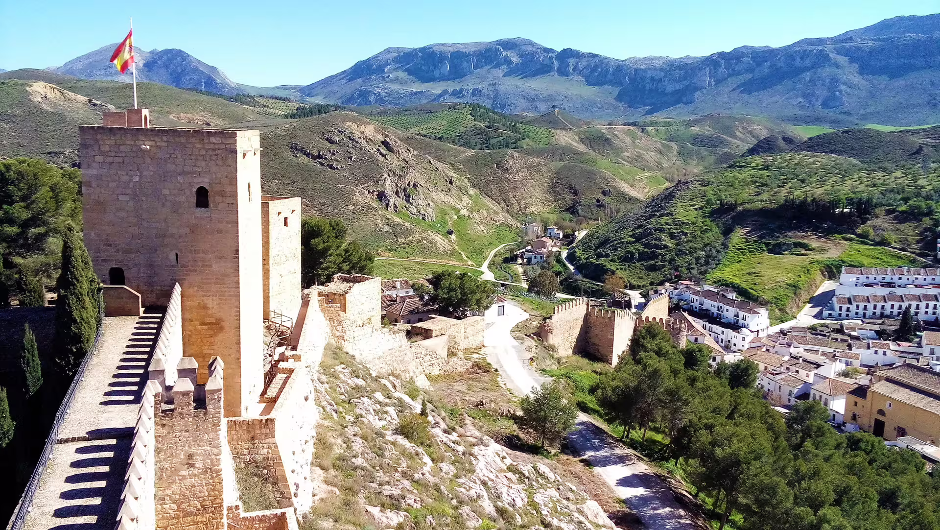 Antequera Alcazaba tower and city walls overlooking Andalusian mountains, featured on private full-day tour from Costa del Sol