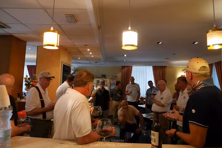 Guests enjoying a lively aperitivo gathering at Hotel Le Pacé, Cassino, highlighting the Monte Cassino history tour.