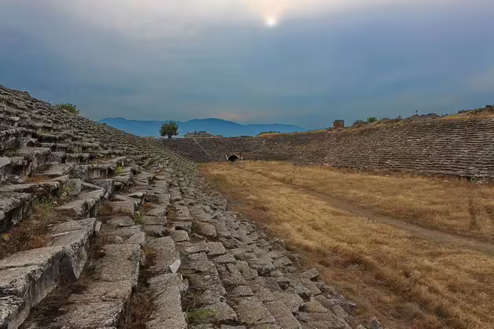 Stadium ruins at Aphrodisias near Pamukkale, Turkey, on a private tour with stone terraces and mountain views