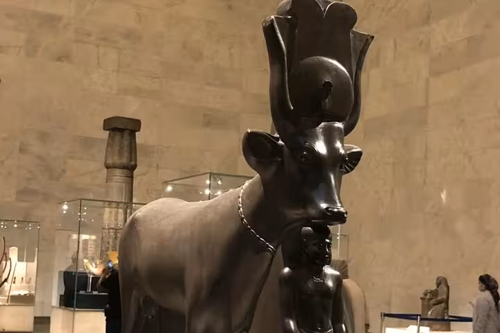 Ancient Egyptian Apis bull statue displayed in the Grand Egyptian Museum, featured on a private Giza pyramids tour