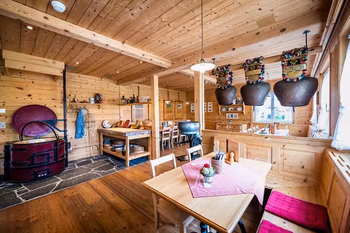 Cozy wooden interior of an Appenzell chalet showcasing traditional Swiss decor and dining ambiance.