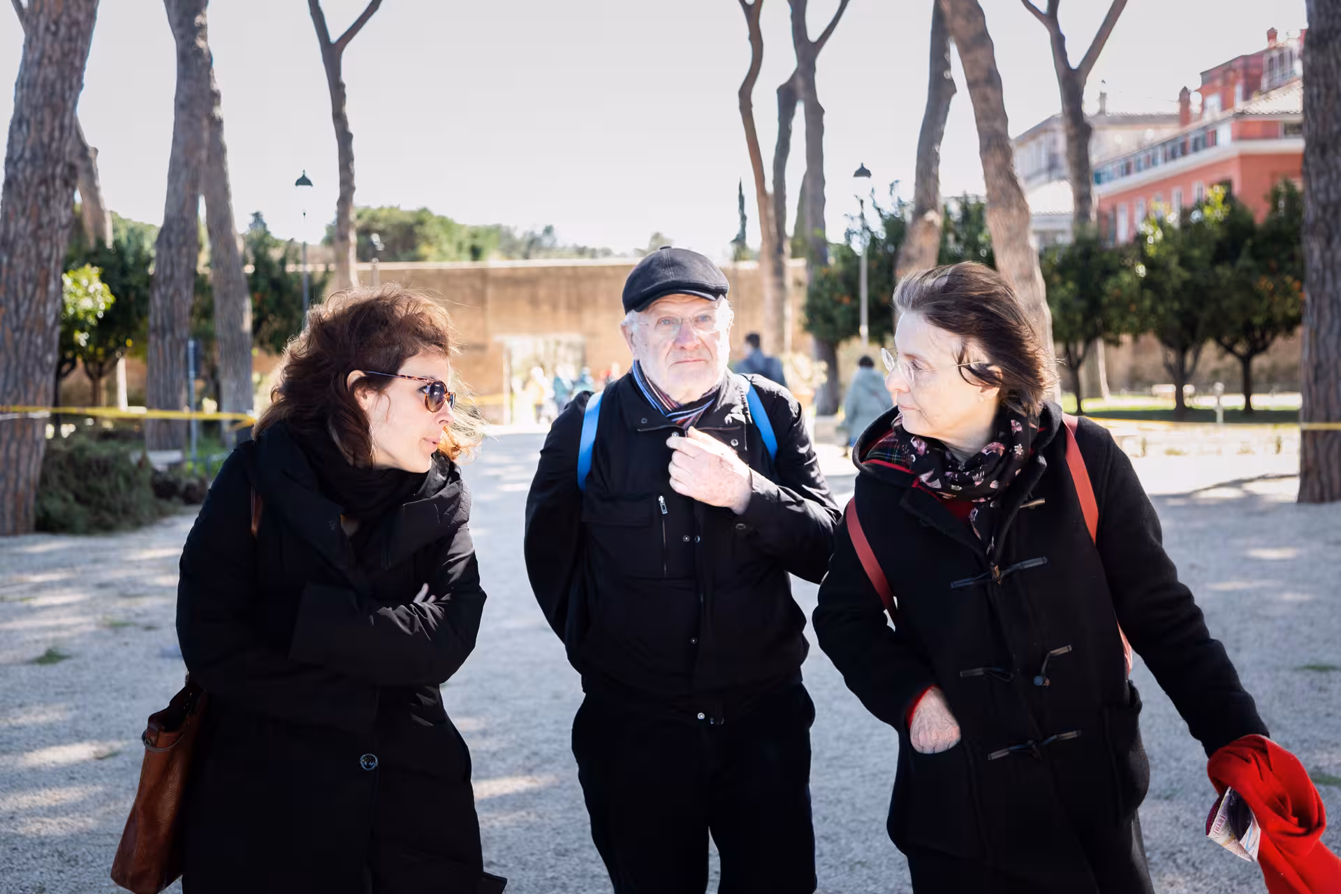 Visitors engaging in a cultural conversation amidst the scenic beauty of Caffarella Valley's historic landscape.