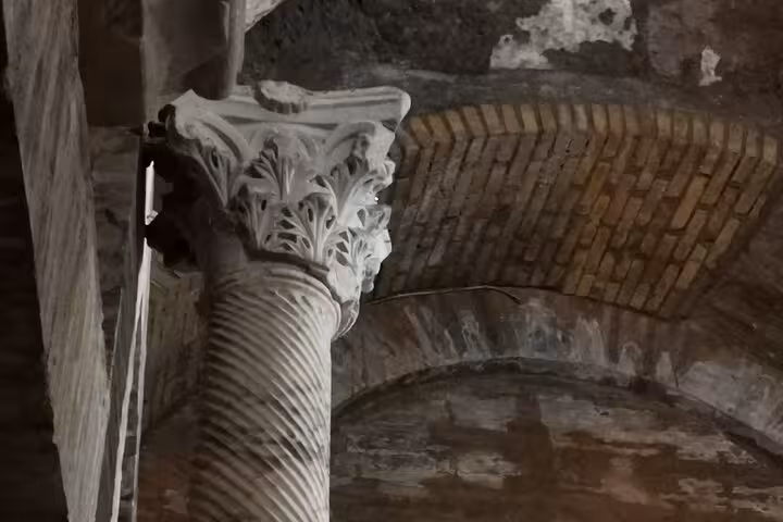 Intricately carved column in the historic Christian catacombs along the Appian Way tour in Rome.