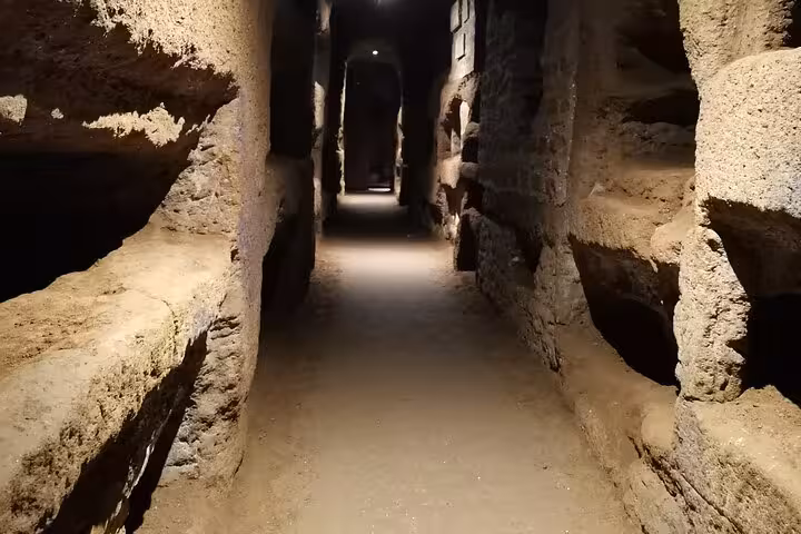Narrow passageway in the Christian catacombs of the Appian Way, offering a glimpse into ancient Roman burial sites.