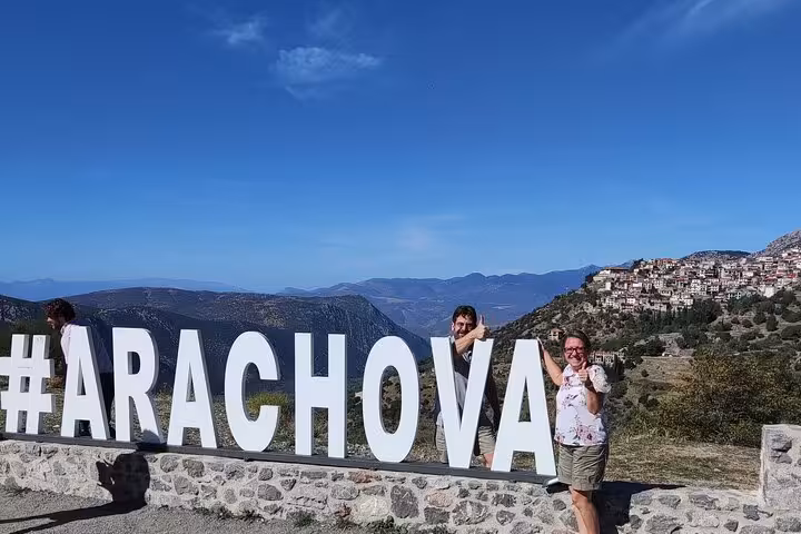 Arachova viewpoint photo stop near Delphi, with iconic #ARACHOVA sign and Parnassus mountain panorama