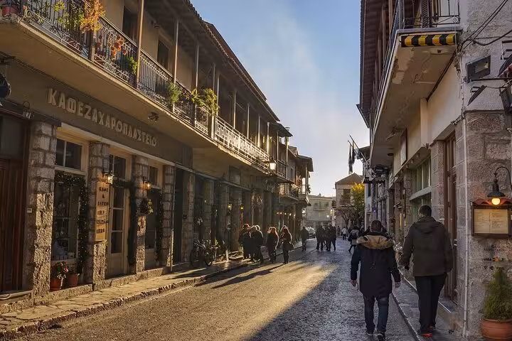 Arachova village street near Delphi with traditional cafes and shops, a scenic stop on a private day trip from Athens