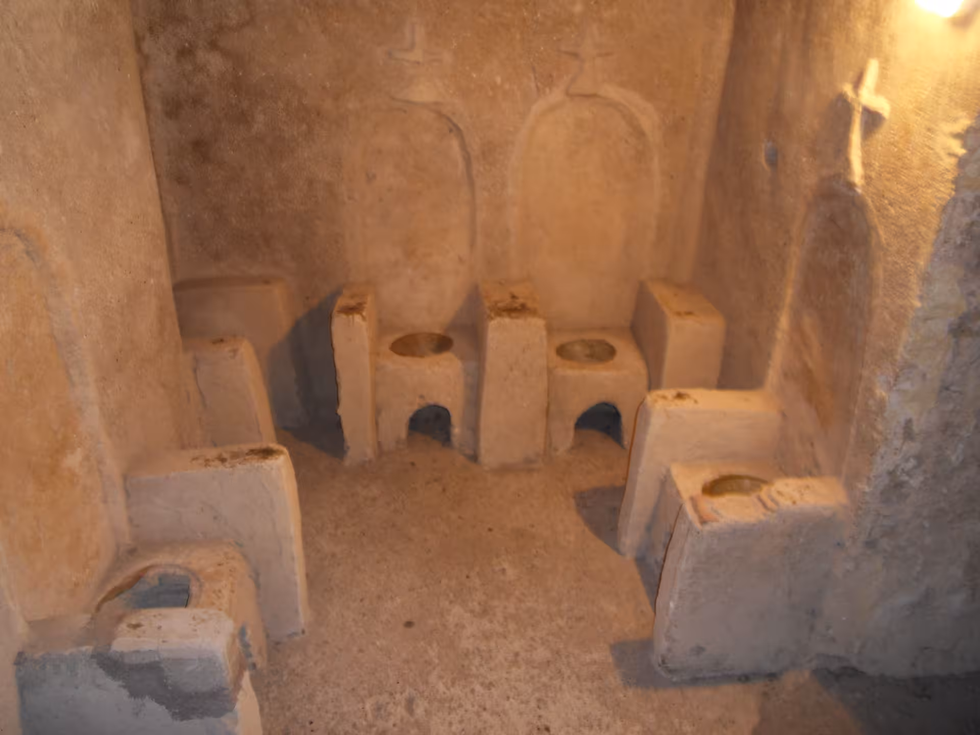 Historic stone latrines inside Aragonese Castle Ischia, guided Italian tour exploring medieval fortress life